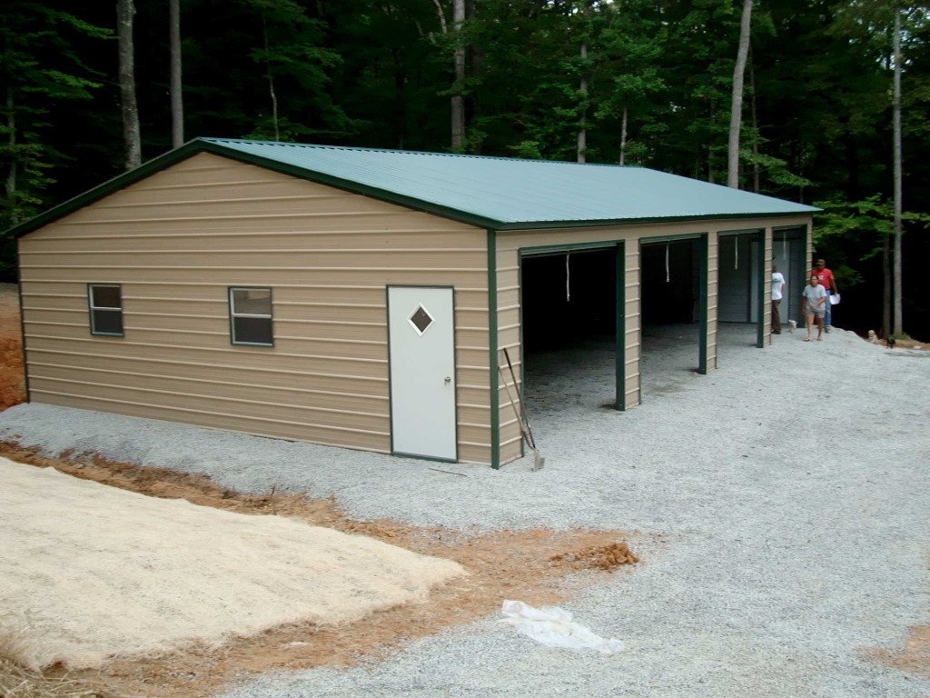 Four car garage building with four roll up garage doors and one walk in door
