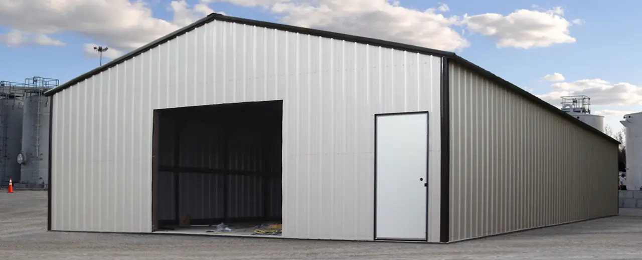 Commercial steel building installed at industrial manufacturing plant.